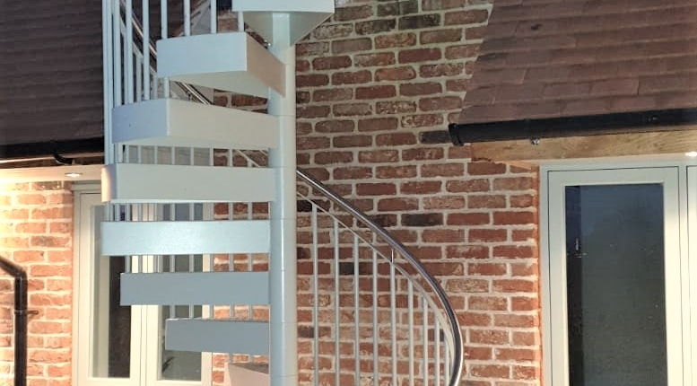 Spiral Staircase with a stainless steel handrail and galvanised and powder coated railings and treads