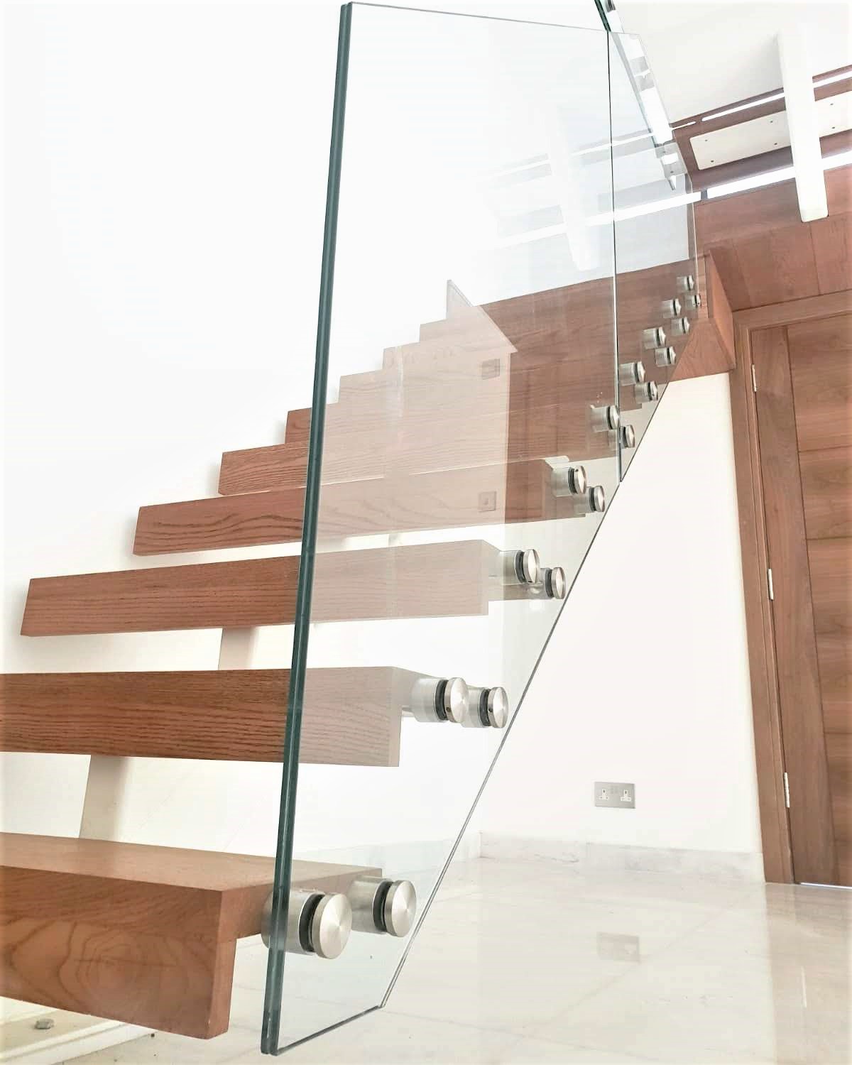 Staircase with walnut stained Oak and frameless glass to one side of the stairs